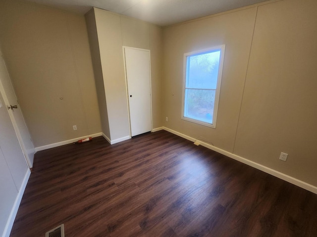 unfurnished bedroom featuring dark hardwood / wood-style flooring