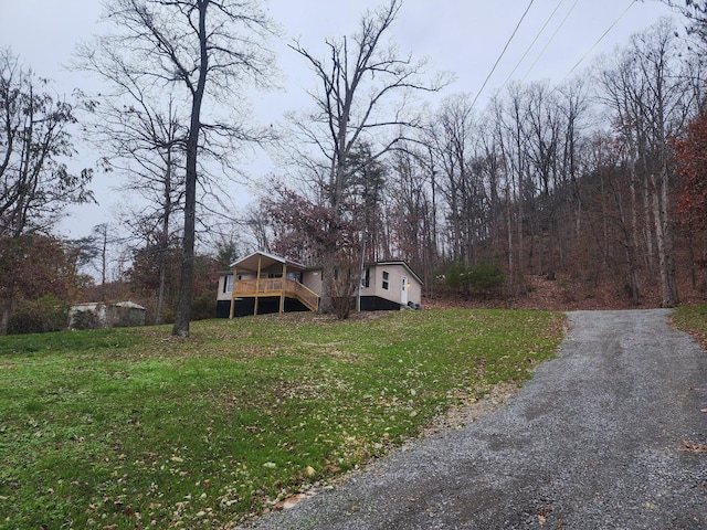 exterior space with a deck and a front lawn