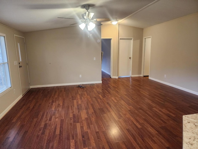 spare room featuring vaulted ceiling, ceiling fan, and dark wood-type flooring