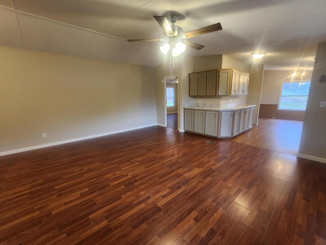 unfurnished living room featuring ceiling fan and dark hardwood / wood-style floors