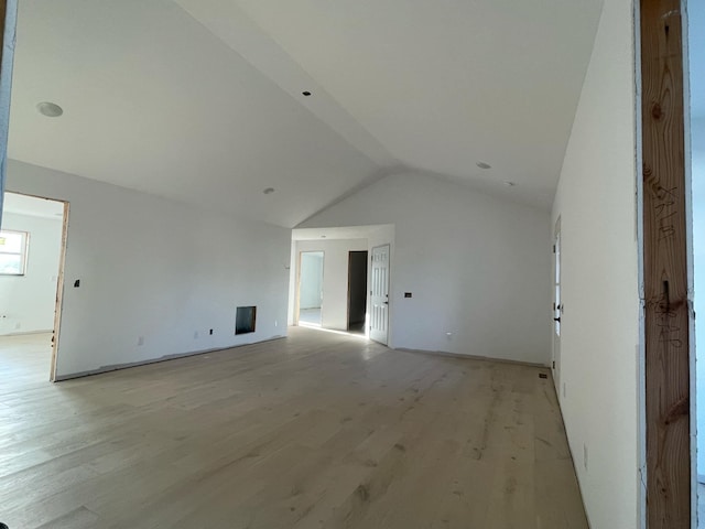 interior space featuring lofted ceiling and light wood-type flooring