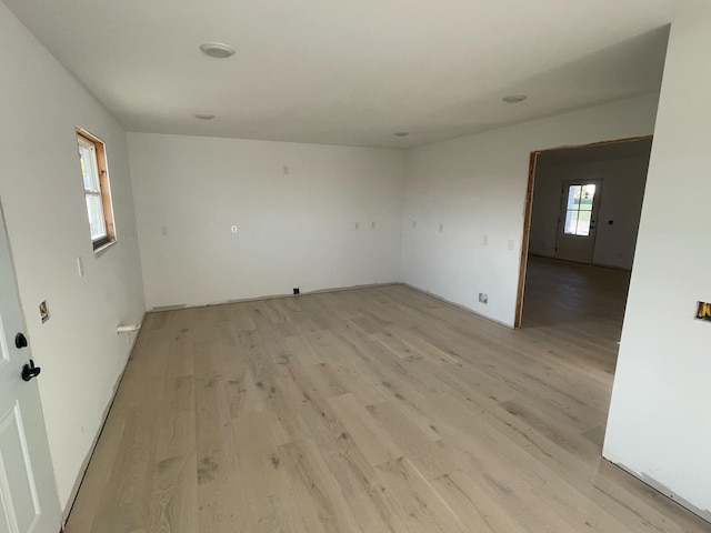 empty room with light hardwood / wood-style flooring