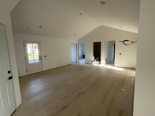 unfurnished living room with light hardwood / wood-style floors and lofted ceiling