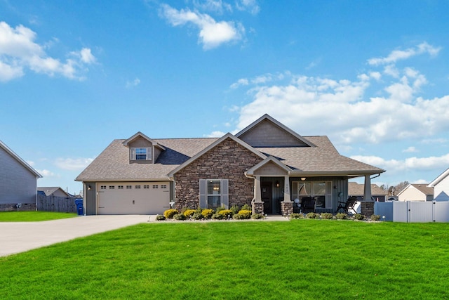 craftsman house featuring a front lawn, covered porch, and a garage