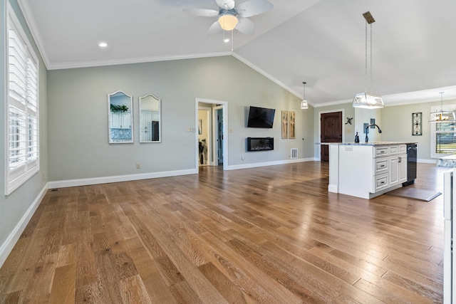 unfurnished living room featuring hardwood / wood-style flooring, a healthy amount of sunlight, and vaulted ceiling