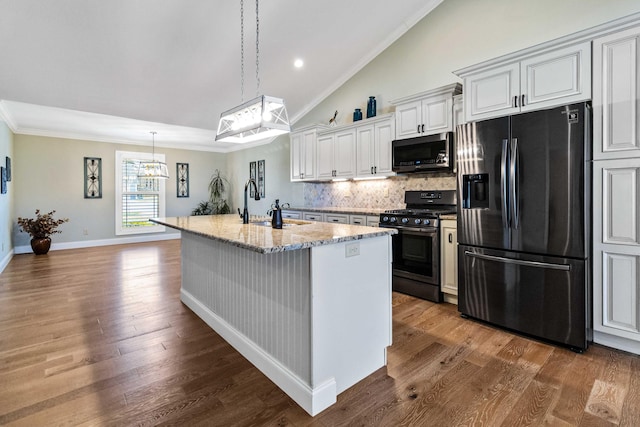 kitchen featuring a center island with sink, white cabinetry, stainless steel appliances, and dark wood-type flooring