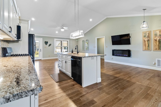 kitchen with dishwasher, hardwood / wood-style floors, pendant lighting, a kitchen island with sink, and white cabinets