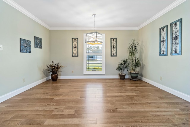 unfurnished dining area featuring crown molding and hardwood / wood-style flooring