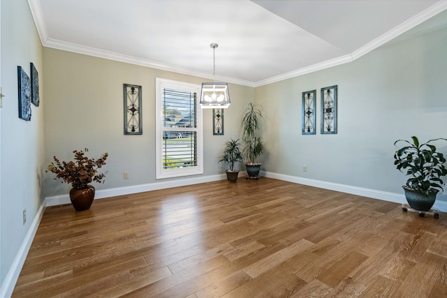 dining space featuring hardwood / wood-style floors, a notable chandelier, and ornamental molding