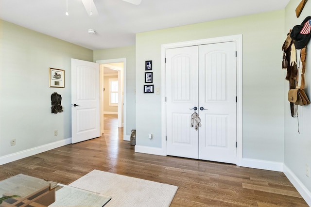 bedroom with ceiling fan, dark hardwood / wood-style floors, and a closet