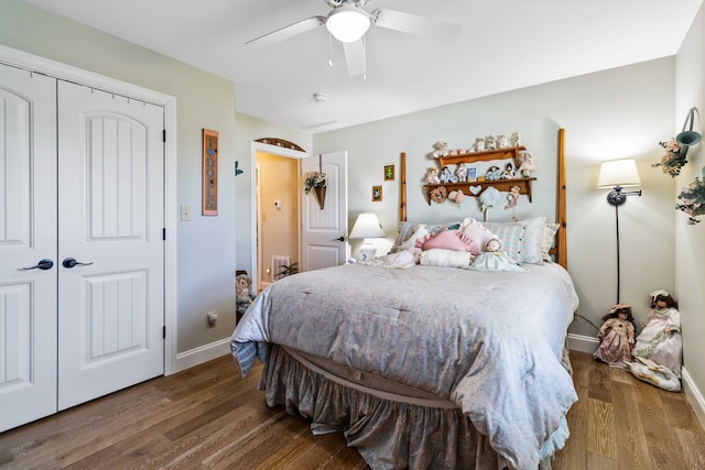 bedroom featuring ceiling fan, a closet, and dark hardwood / wood-style floors