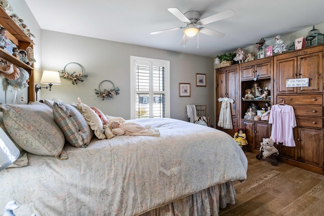 bedroom with dark hardwood / wood-style floors and ceiling fan