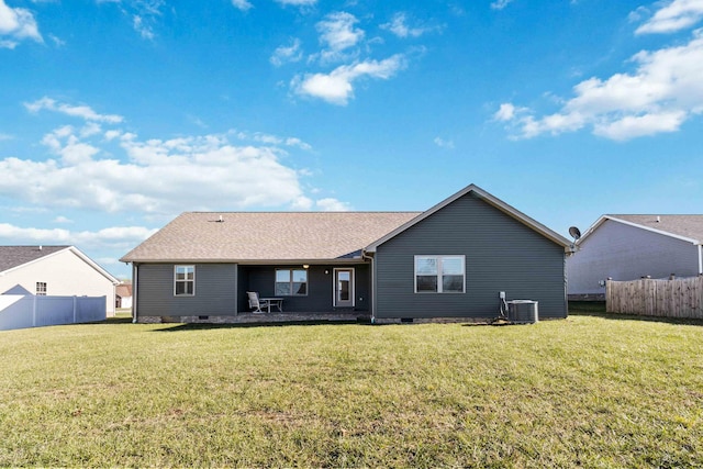 rear view of property with a lawn and central air condition unit