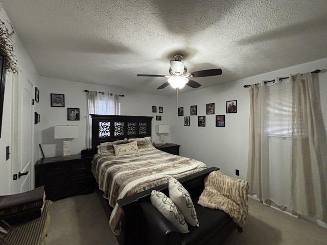 bedroom with a textured ceiling, ceiling fan, and carpet