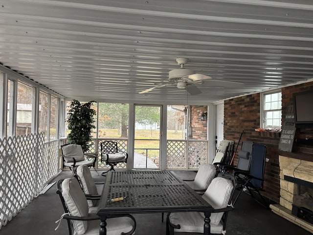 sunroom / solarium featuring ceiling fan