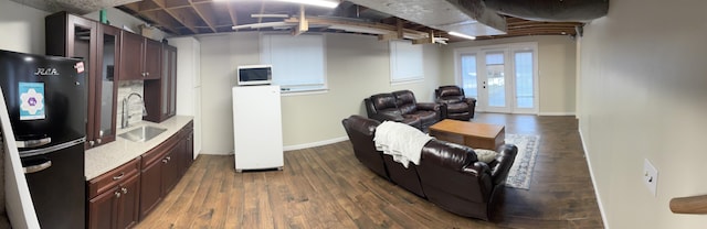 living room featuring sink and dark hardwood / wood-style floors