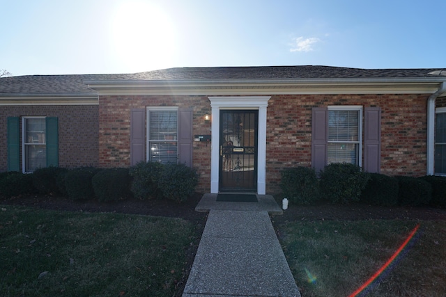 property entrance featuring a lawn