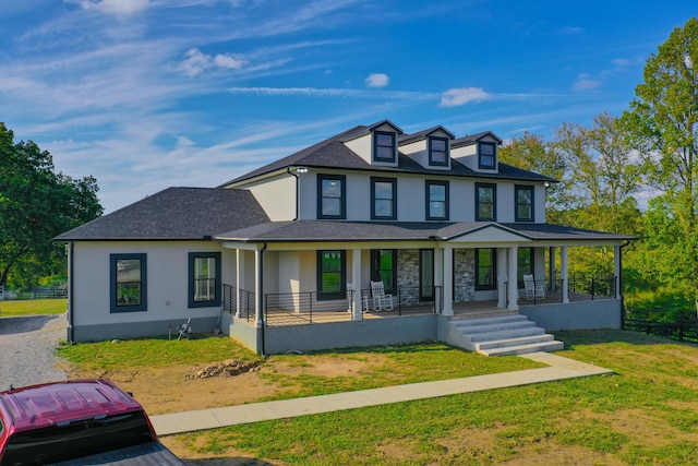 view of front of property with covered porch and a front yard