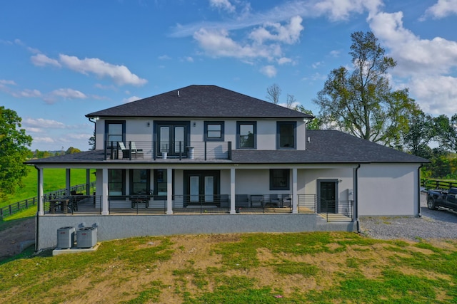 rear view of property with french doors and central AC