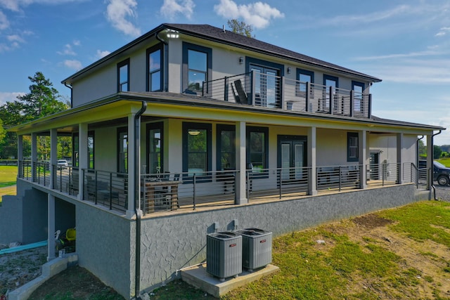 view of side of home featuring a balcony and central AC