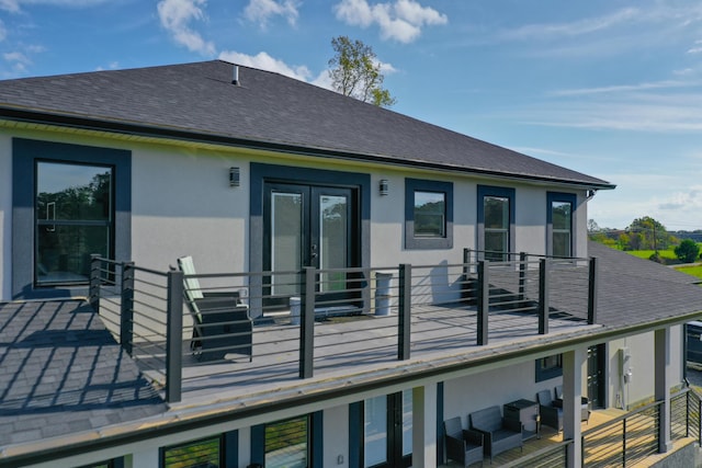 back of house featuring a balcony