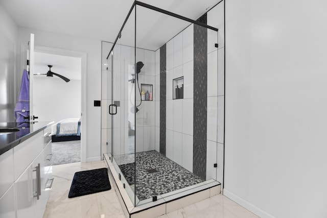 bathroom featuring ceiling fan and an enclosed shower