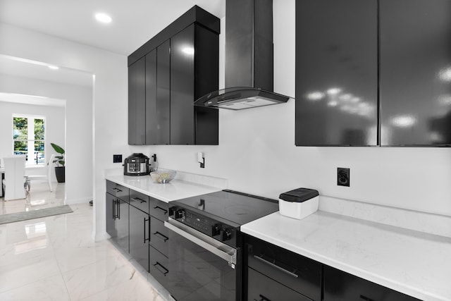 kitchen with wall chimney range hood and stainless steel electric range oven