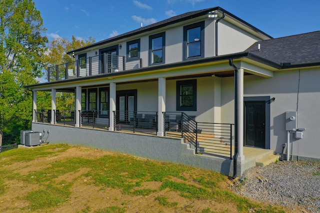 exterior space with central AC unit and a balcony