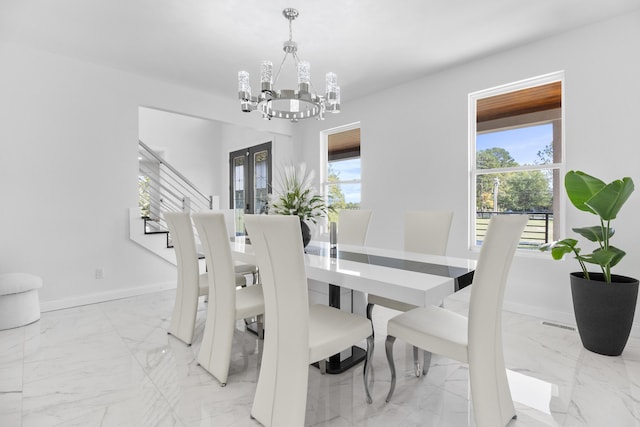 dining room featuring plenty of natural light and a chandelier