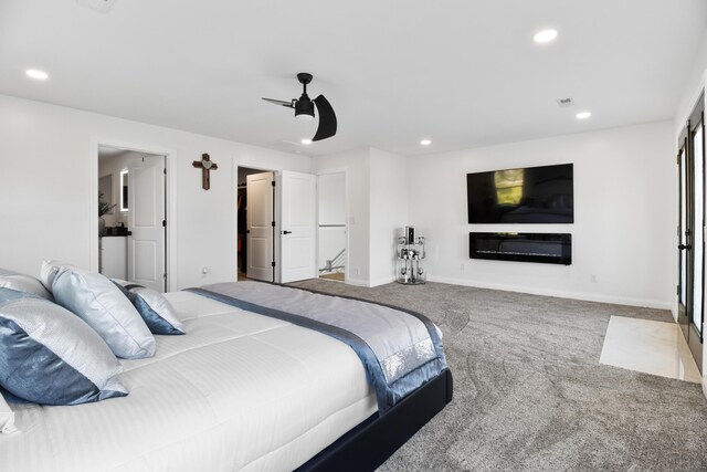 carpeted bedroom with ceiling fan and multiple windows