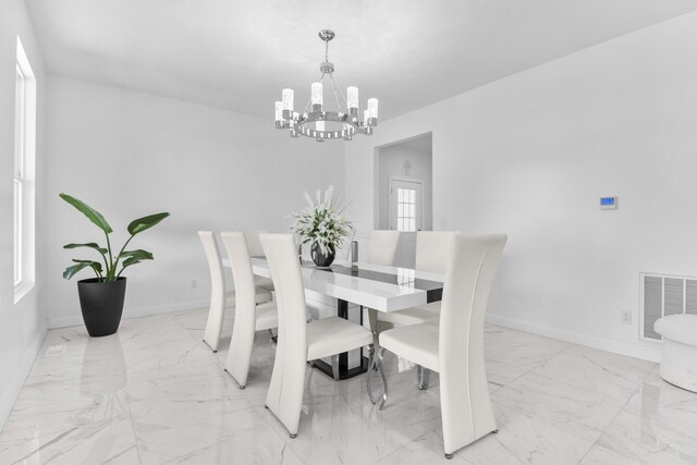 dining space featuring a chandelier