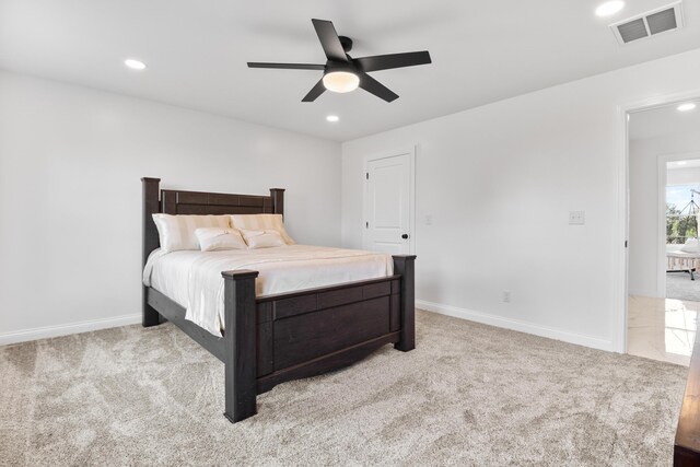 bedroom featuring carpet flooring, a walk in closet, ceiling fan, and a closet