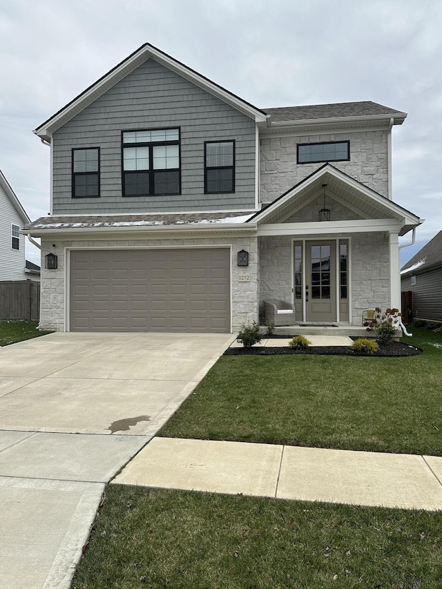 view of front of property with a front yard and a garage