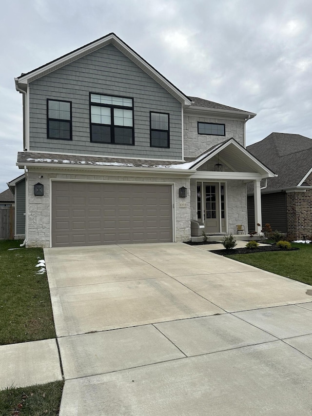 view of front of home featuring covered porch and a garage