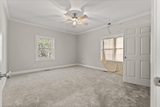 unfurnished room featuring light colored carpet, ceiling fan, and ornamental molding