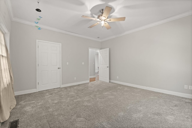 unfurnished bedroom featuring carpet, ceiling fan, and crown molding