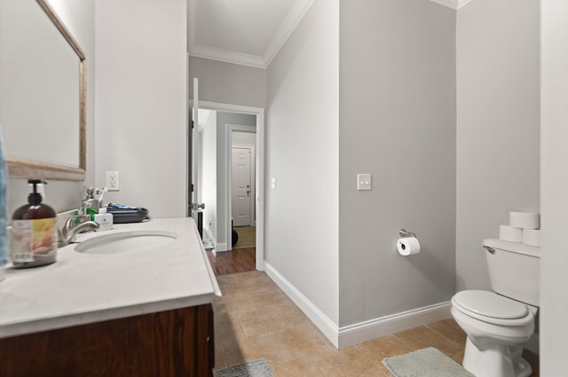 bathroom with tile patterned flooring, vanity, toilet, and ornamental molding