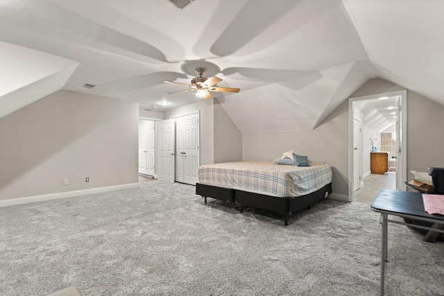 carpeted bedroom with a closet, ceiling fan, and lofted ceiling