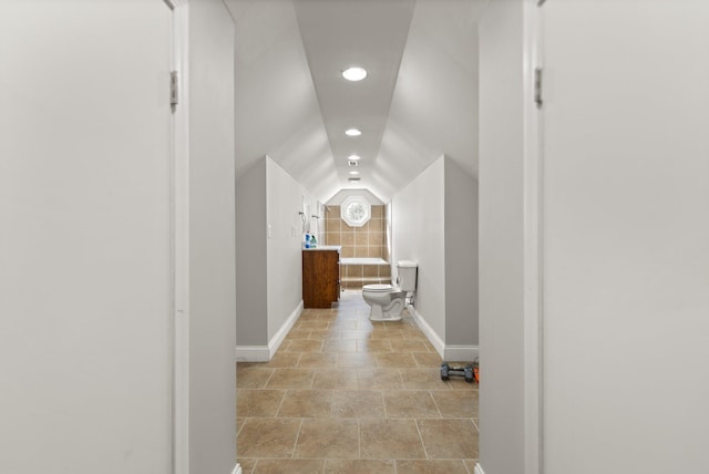 corridor featuring vaulted ceiling