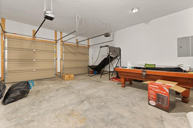 garage featuring electric panel and a garage door opener