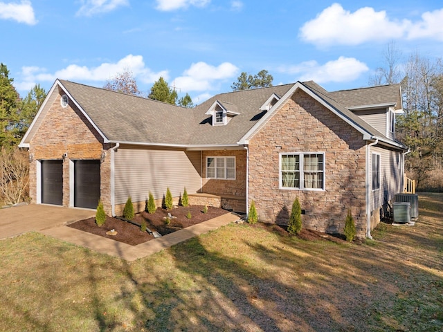 view of front of property with central AC unit, a front yard, and a garage