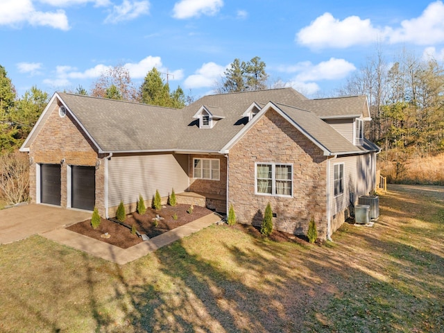 view of front of house with central AC, a garage, and a front lawn