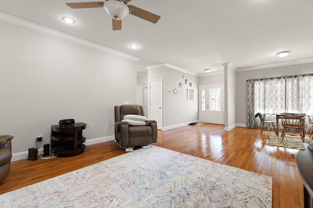 sitting room featuring hardwood / wood-style flooring, ceiling fan, and ornamental molding