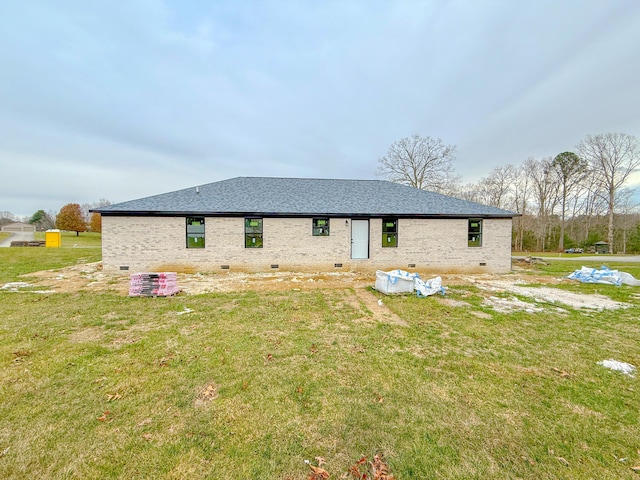 rear view of house with a lawn and cooling unit