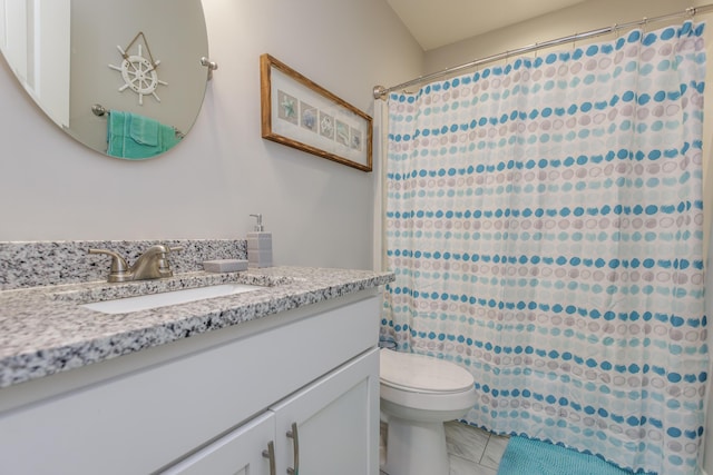 bathroom featuring tile patterned floors, vanity, and toilet