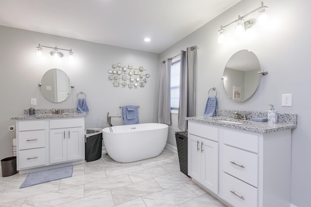 bathroom with a tub to relax in and vanity