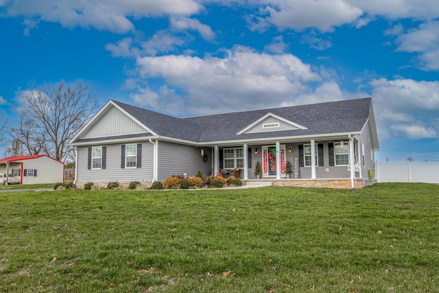 single story home featuring covered porch and a front lawn