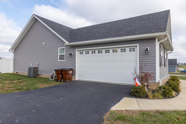 view of side of property with cooling unit and a garage