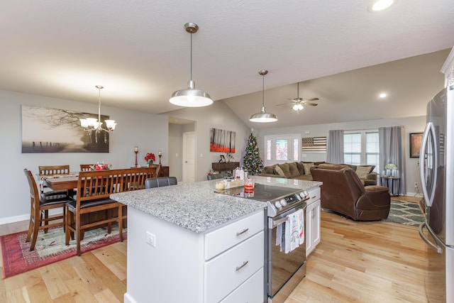 kitchen with light wood-type flooring, white cabinetry, and appliances with stainless steel finishes