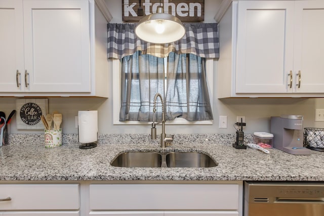 kitchen featuring dishwasher, white cabinetry, and sink